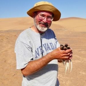 Photo of Al Muth, PhD Holding Lizards at Boyd Desert Center for Research